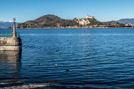 Landscape of the castle of Angera and the city from the port of Aronaの写真素材