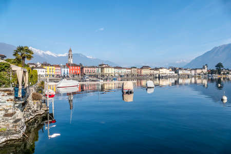 Panorama of Ascona with houses with colorful facades reflecting on Lake Maggioreの写真素材