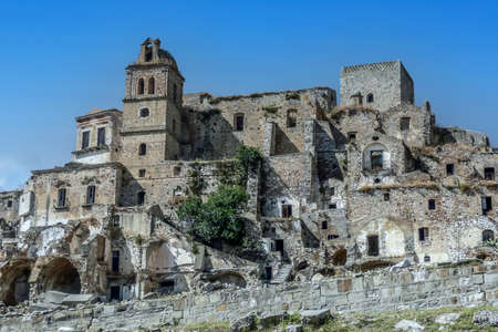 landscape of the ghost town of Craco, with abandoned houses in ruins due to a landslideの写真素材