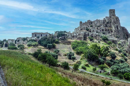 landscape of the ghost town of Craco, with abandoned houses in ruins due to a landslideの写真素材