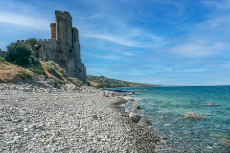 Roseto Capo Spulico, Italy - 07/02/2016: The beach with the green sea and the castle that overlooks itのeditorial素材
