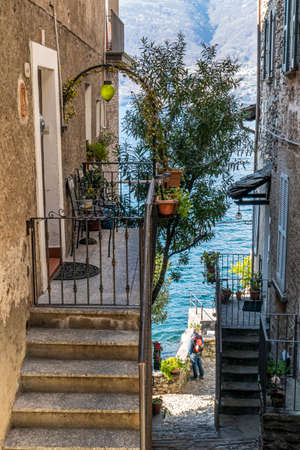 Corenno Plinio with stone houses, plants and flowersの写真素材
