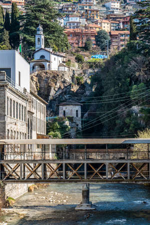 Covered bridge with a church in the background in Bellanoの写真素材