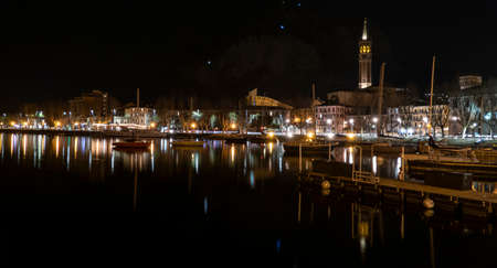 the long lake of Lecco illuminated at nightの写真素材