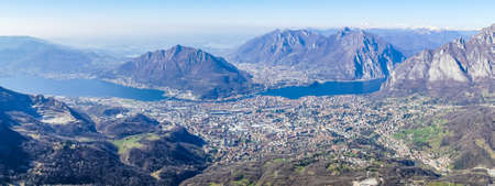 Extra wide view of the Lake of Lecco and the sorrounding mountainsの写真素材