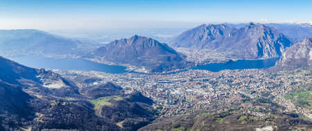 Extra wide view of the Lake of Lecco and the sorrounding mountainsの写真素材