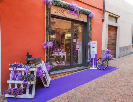 Luino, Italy - 04-19-2021: beautiful street in the historic center of Luino with flowers, lavender and porphyryのeditorial素材