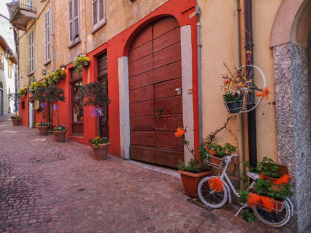 Luino, Italy - 04-19-2021: beautiful street in the historic center of Luino with flowers, lavender and porphyryのeditorial素材