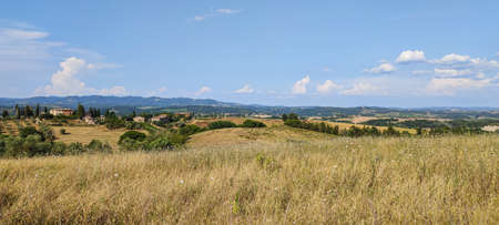 Extra wide view of the Tuscan hills with Siena in the backgroundの写真素材
