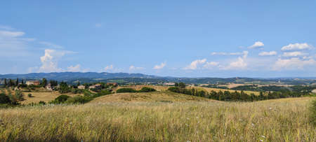 Extra wide view of the Tuscan hills with Siena in the backgroundの写真素材