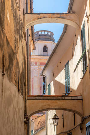Ancient street with arches in the historic center of Diano Castelloの写真素材
