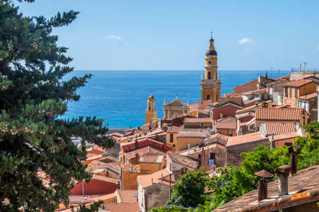 aerial view of the historic center of Menton with the beautiful Basilica and blue seaの写真素材