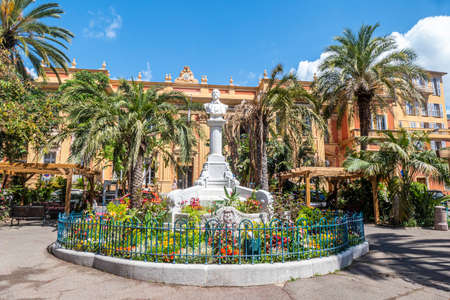 Menton, France - 07-07-2021: Beautiful garden in Menton with the railway station in the backgroundのeditorial素材