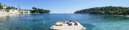 Extra wide view of the beautiful Fosses Beach in Saint Jean Cap Ferrat with tropical colored waterのeditorial素材