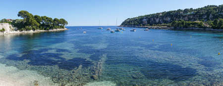 Extra wide Aerial view of the beautiful Fosses Beach in Saint Jean Cap Ferrat with tropical colored waterの写真素材