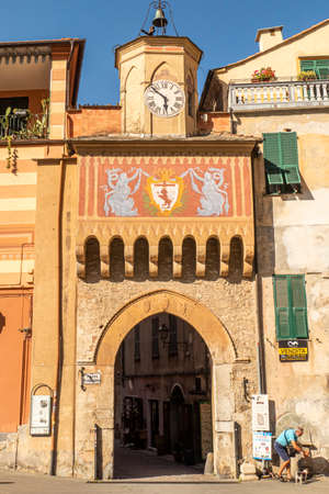 Finalborgo, Italy - 04-07-2021: Beautiful arch with decorated facade and clock tower in Finalborgoのeditorial素材