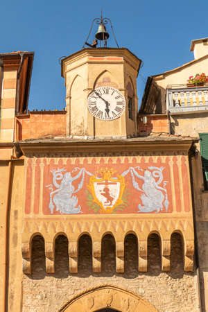 Finalborgo, Italy - 04-07-2021: Beautiful arch with decorated facade and clock tower in Finalborgoのeditorial素材