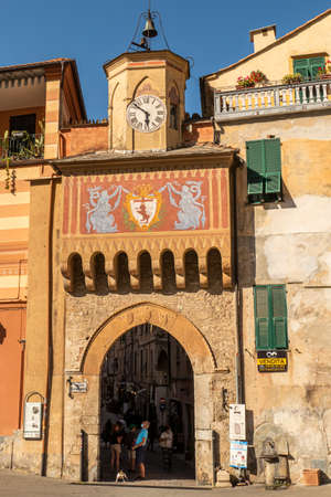 Finalborgo, Italy - 04-07-2021: Beautiful arch with decorated facade and clock tower in Finalborgoのeditorial素材