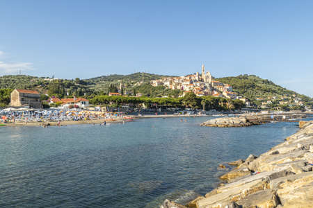Cervo, Italy - 04-07-2021: Cervo beach with its characteristic rocks and the beautiful town in the backgroundの写真素材