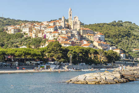 Cervo, Italy - 04-07-2021: Cervo beach with its characteristic rocks and the beautiful town in the backgroundの写真素材