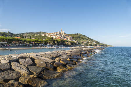Cervo, Italy - 04-07-2021: Cervo beach with its characteristic rocks and the beautiful town in the backgroundの写真素材