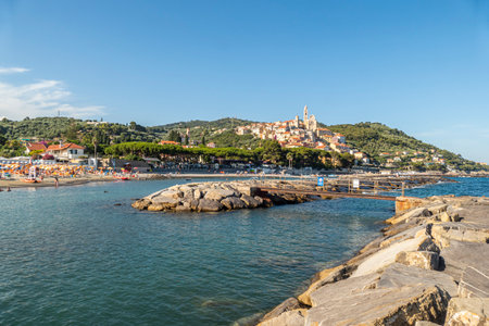 Cervo, Italy - 04-07-2021: Cervo beach with its characteristic rocks and the beautiful town in the backgroundのeditorial素材