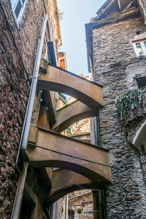 Dolceacqua, Italy - 06-07-2021: Characteristic small streets in the historic center of Dolceacqua with arches and flowersのeditorial素材
