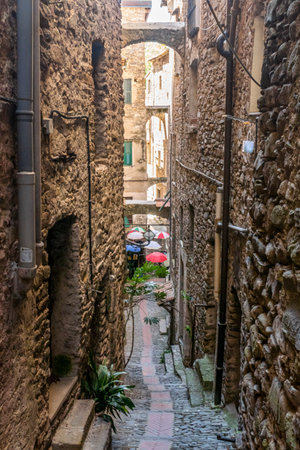 Dolceacqua, Italy - 06-07-2021: Characteristic small streets in the historic center of Dolceacqua with arches and flowersのeditorial素材