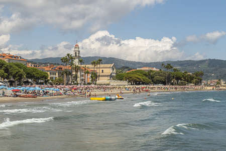 Diano Marina, Italy - 10-07-2021: The beach of Diano Marina with a beautiful church in backgroundのeditorial素材