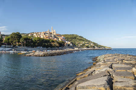 Cervo, Italy - 04-07-2021: Cervo beach with its characteristic rocks and the beautiful town in the backgroundのeditorial素材