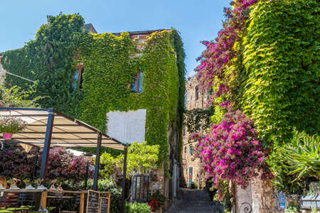 Bussana Vecchia, Italy - 04-07-2021: Ancient streets to houses in Bussana Vecchia damaged and earthquake with plants and flowersのeditorial素材