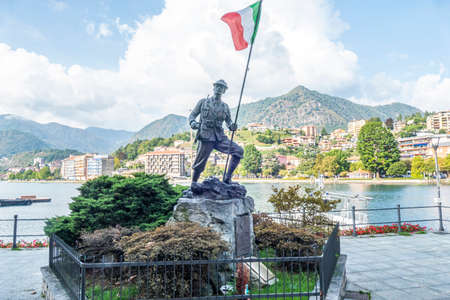 Omegna, Italy - 09-13-2021: Nice monument of an Alpino with the Italian flag and Omegna in the backgroundのeditorial素材