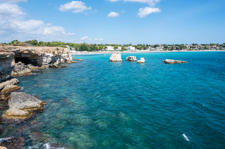 beautiful cliff with clear and crystalline turquoise water in Sicily in Syracuse with the beach of Fontane Bianche in the backgroundの写真素材