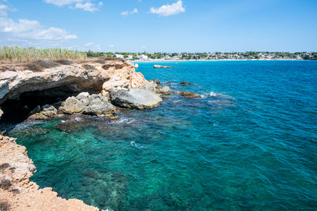 beautiful cave with clear and crystalline turquoise water in Sicily in Syracuse with the beach of Fontane Bianche in the backgroundの写真素材