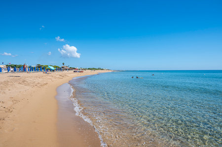 The beautiful Beach of Correnti with transparent and blue water in Portopalo in Sicily with the Island of Correnti in backgroundの写真素材