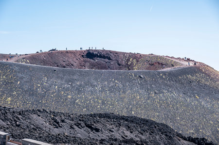 A Silvestre crater of the Etna volcano with people on the edge of the craterの写真素材