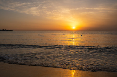 A wonderful sunrise with beautiful colors on the sea seen from the beach of the roundabout on the sea of Avolaの写真素材