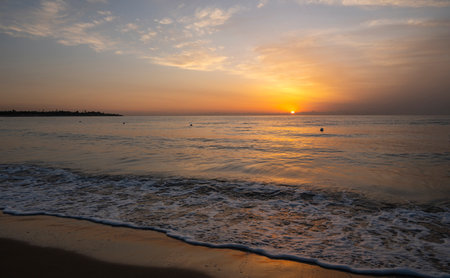 A wonderful sunrise with beautiful colors on the sea seen from the beach of the roundabout on the sea of Avolaの写真素材