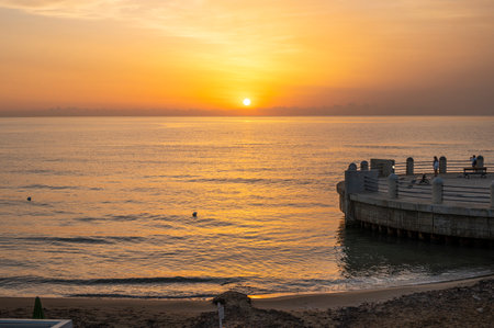 A wonderful sunrise with beautiful colors on the sea seen from the beach of the roundabout on the sea of Avolaの写真素材
