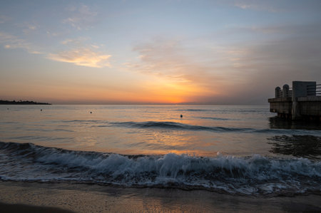 A splendid sunrise with its beautiful colors on the sea seen from the beach of Avola near the roundabout on the seaの写真素材