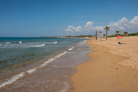 Portopalo, Italy - 09-17-2022: Beautiful beach with sand, turquoise and green water and dunes in Portopalo di Capopasseroのeditorial素材
