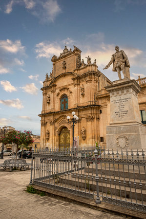 Scicli, Italy: 09-18-2022: The beautiful Busacca Square in Scicli with monument and churchのeditorial素材