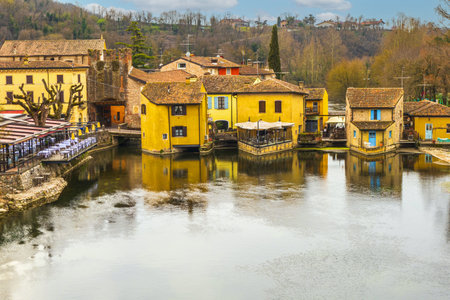 Valeggio, Italy - 03-02-2022: High angle view of Valeggio sul Mincio with the buildings reflecting on the waterのeditorial素材