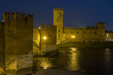 The Castelvecchio in Verona and the Adige River illuminated at nightのeditorial素材