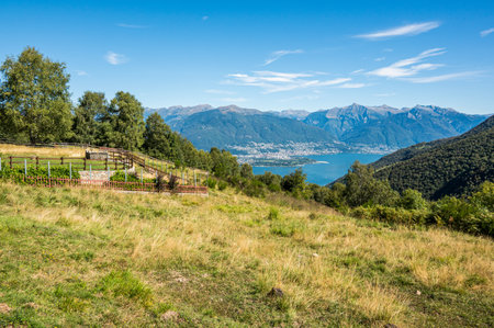 Aerial view of Locarno and the Swiss Alps from an alpine pastureの写真素材