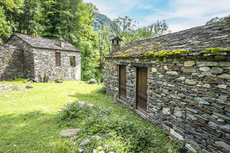 Ruined stone houses and mills in an abandoned mountain village in the Alpsの写真素材