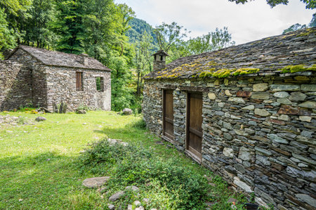 Ruined stone houses and mills in an abandoned mountain village in the Alpsの写真素材