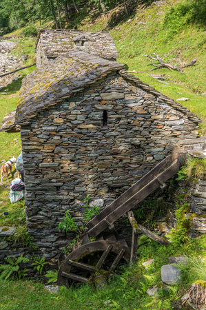 Stone watermill with wooden wheel in an abandoned mountain village in the Alpsの写真素材