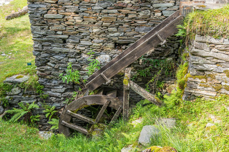 Stone watermill with wooden wheel in an abandoned mountain village in the Alpsの写真素材