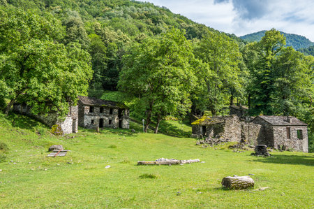 Ruined stone houses and mills in an abandoned mountain village in the Alpsの写真素材